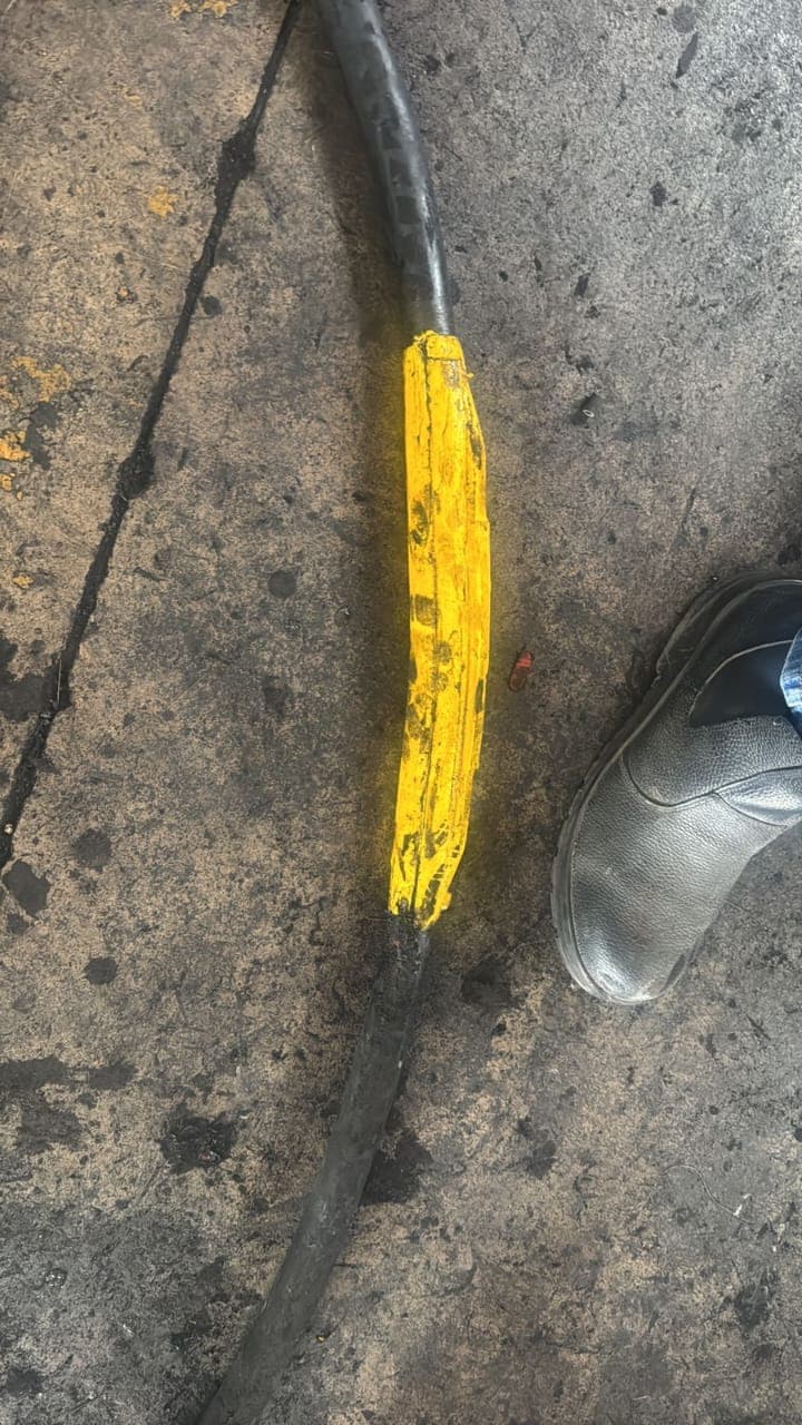 A Bosworth Flexable resin cable joint cured on a trailing cable on the ground, boot alongside for scale