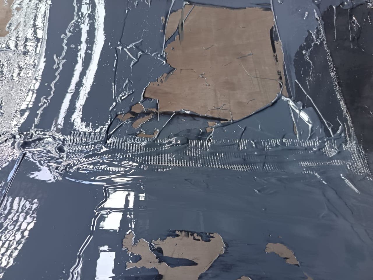 A KK-Fix repair part way through curing, showing the reinforcing scrim under the compound