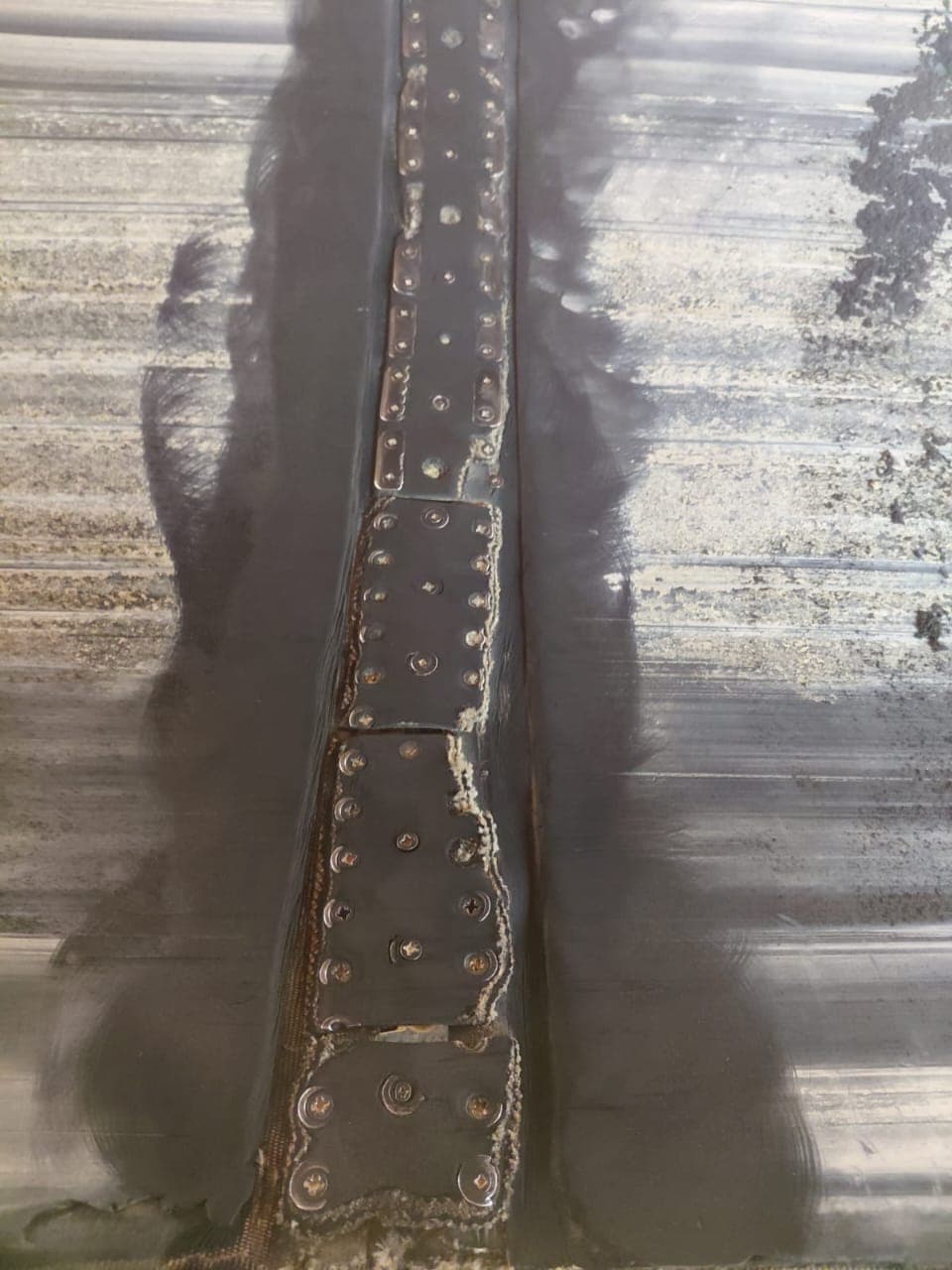 Close-up of a mechanically fastened conveyor belt splice prepared for a KK-Fix cover seal